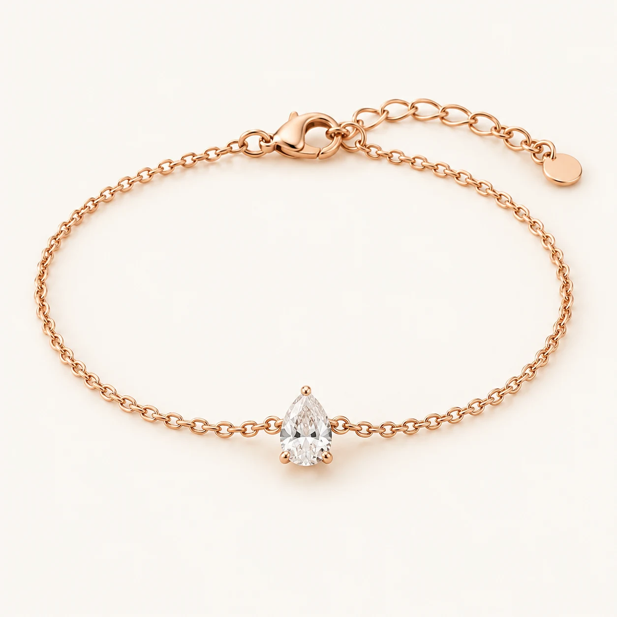 Blush Dew in Rose Gold, fine chain bracelet, one clear pear shaped cubic zirconia drop centered on chain, lobster clasp and extender