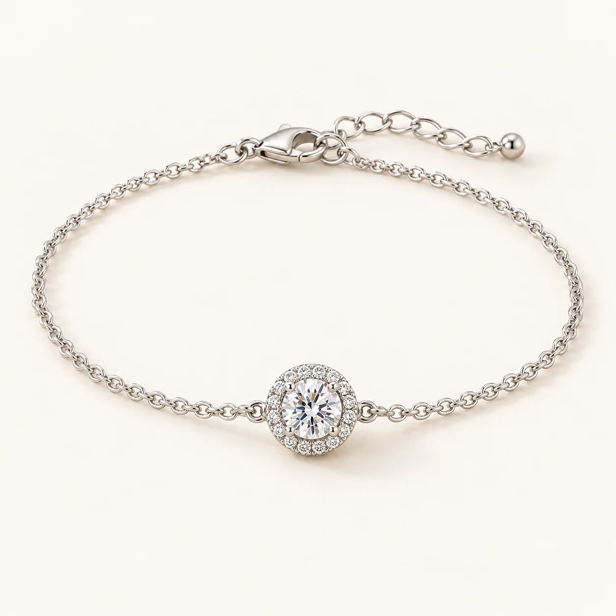 Halo Poise in Silver, fine chain bracelet with one round clear cubic zirconia surrounded by circular halo of tiny clear cubic zirconia, lobster clasp and extender