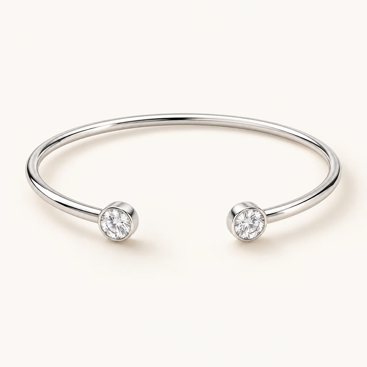 Celeste Arc in Silver, open cuff bracelet, two separate open ends each capped with one round clear cubic zirconia bezel, smooth slender arc, no hinge
